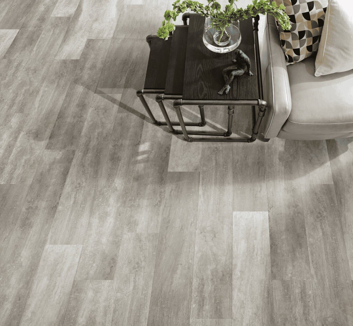 Grey vinyl flooring in a room with grey sofa and three nested occasional tables