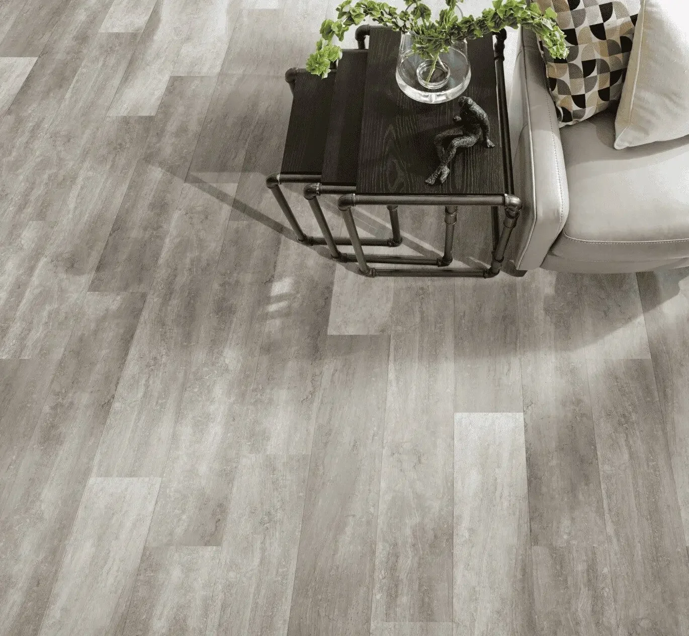 Grey vinyl flooring in a room with grey sofa and three nested occasional tables