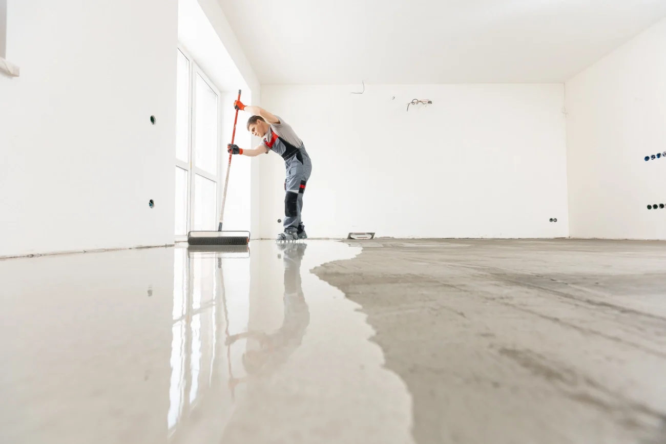 Flooring professional applying epoxy flooring