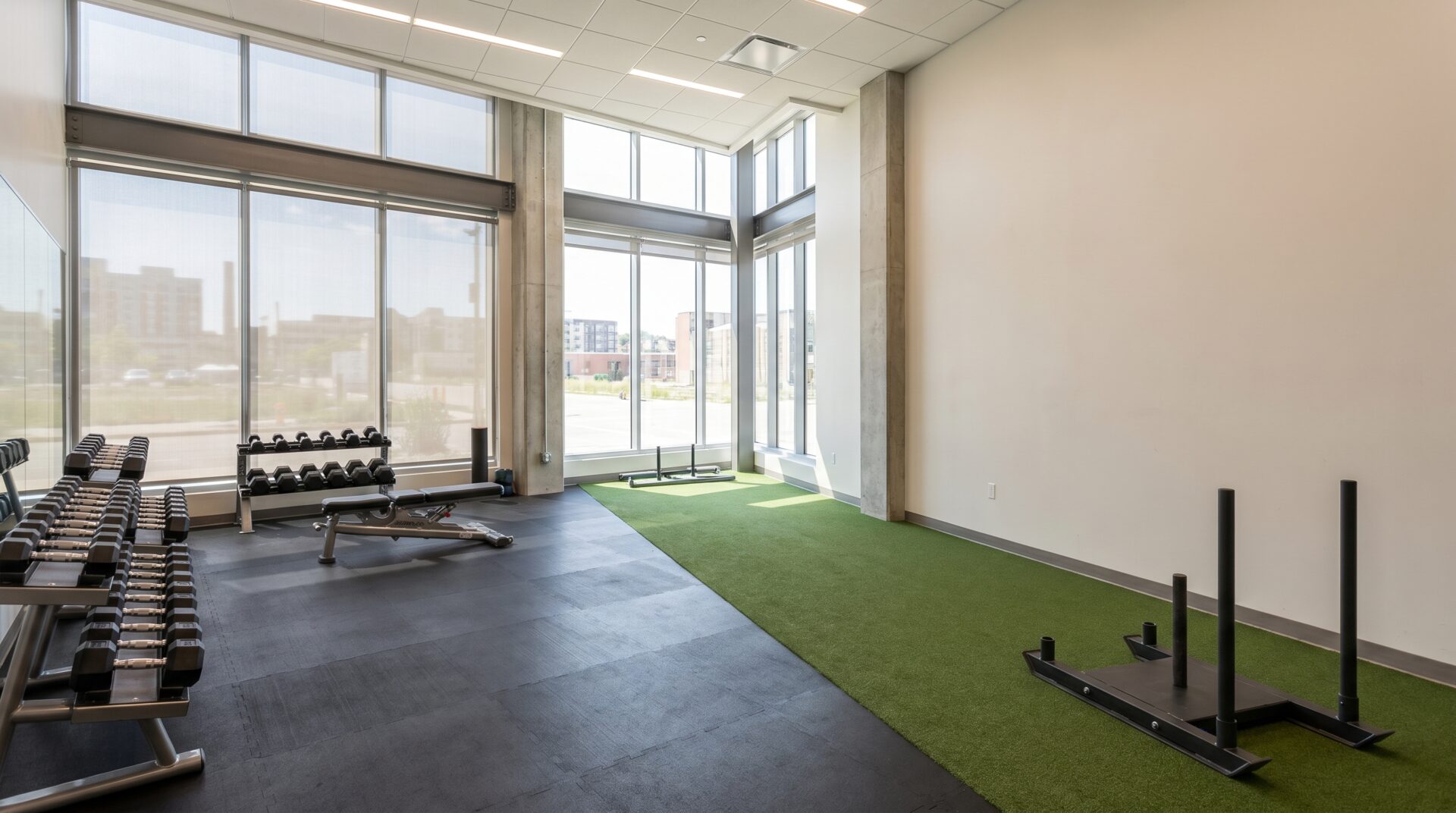 Zoned gym flooring with rubber and turf lane in a Madison fitness studio