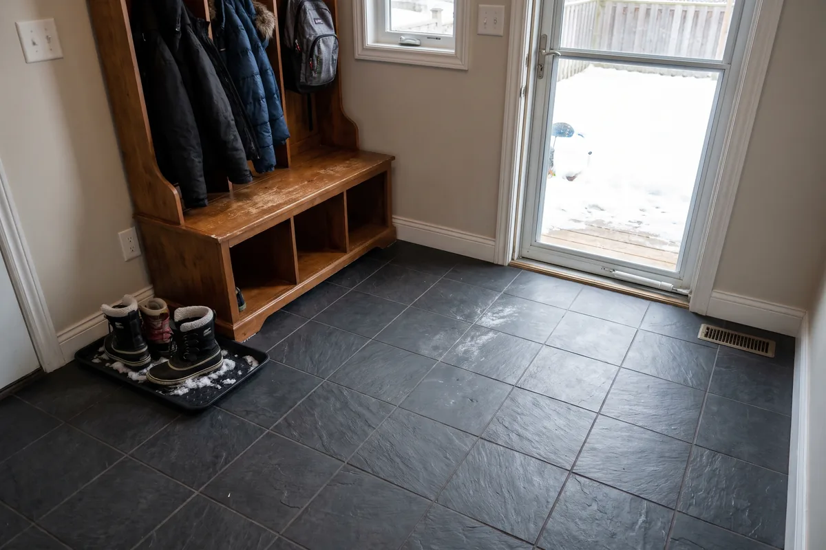 Dark slate-look porcelain tile in a mudroom on a winter day