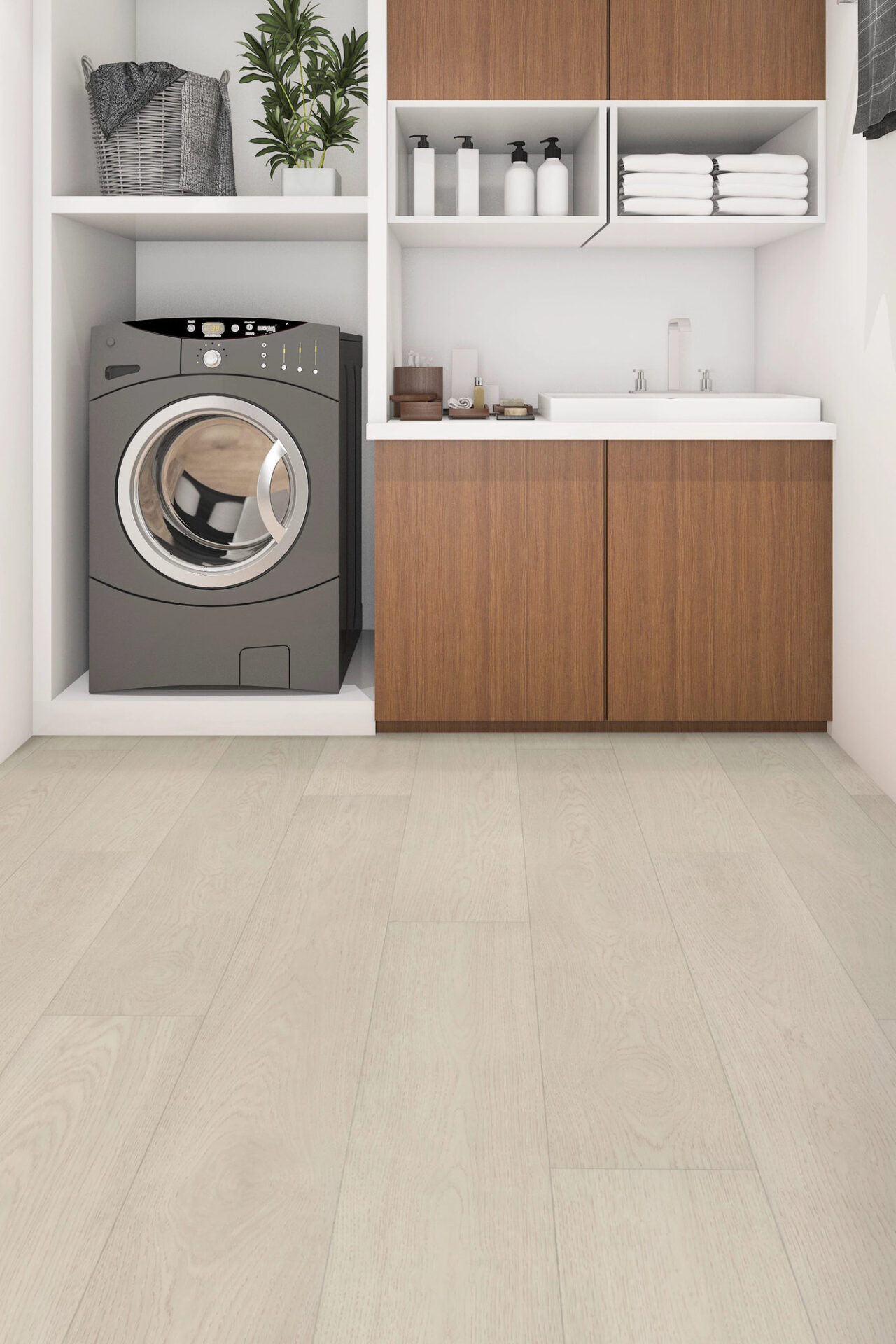 Pale wood-look vinyl plank flooring in a laundry room with a front-load washer and cabinets