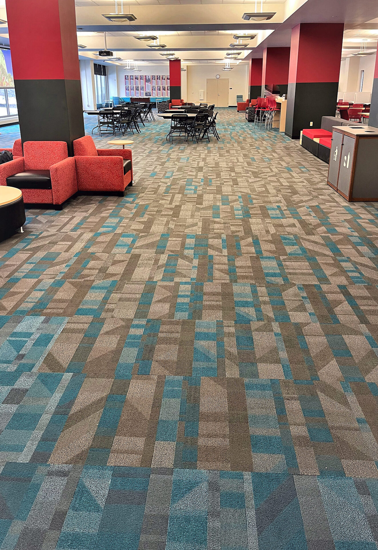 Teal, red and tan patterned commercial carpet tile in a university student lounge