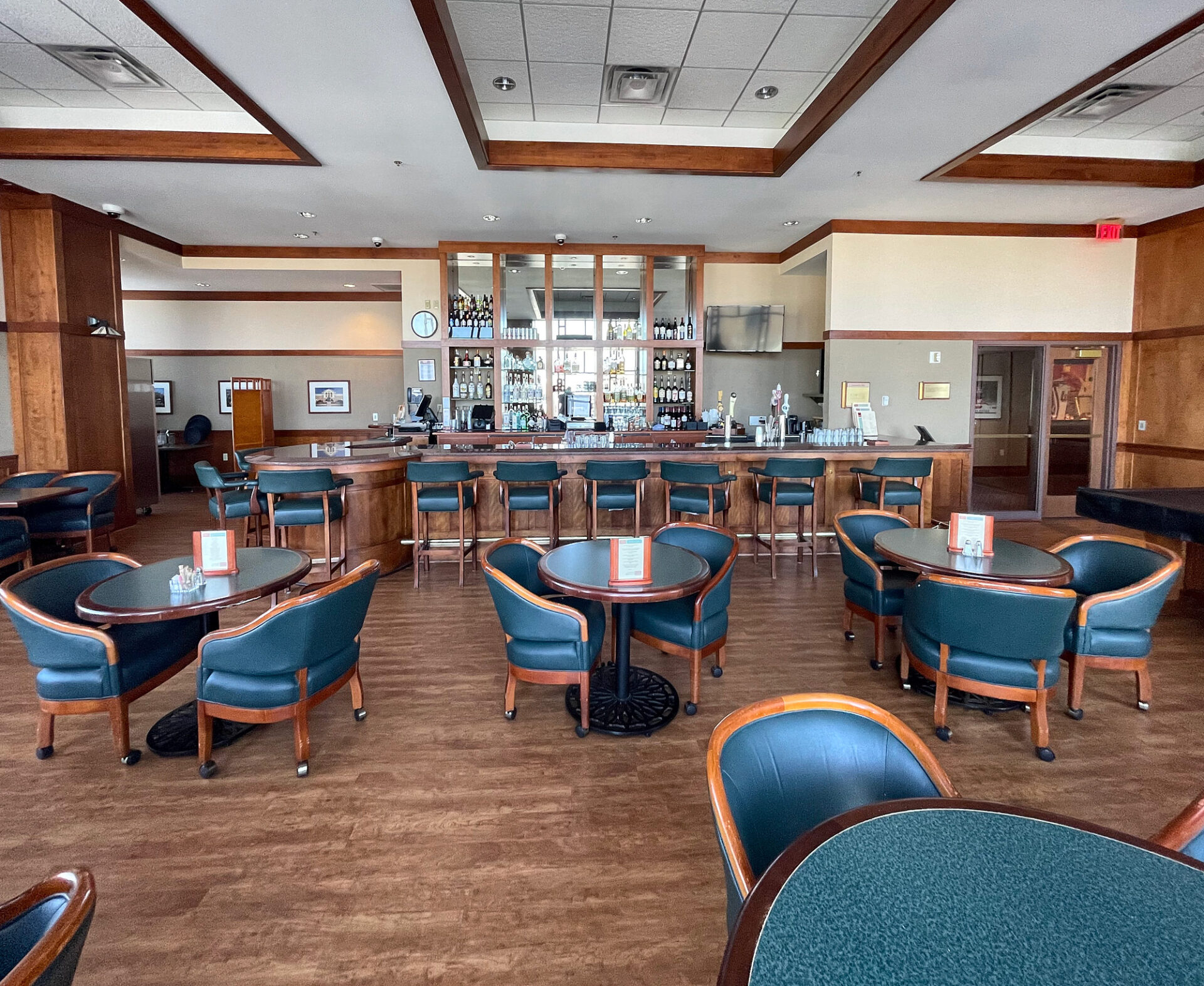 Wood-look commercial luxury vinyl tile flooring through a club dining room and bar seating area