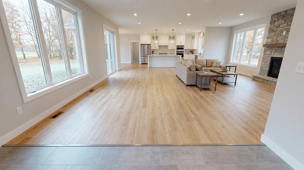 Light oak luxury vinyl plank flooring in a new Verona, Wisconsin home with a flush transition to tile